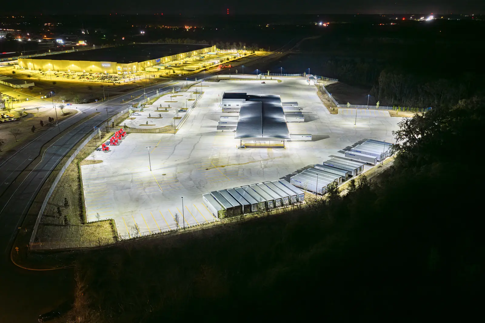Night aerial view of the Averitt service center building signage and yard illumination, Ocala FL