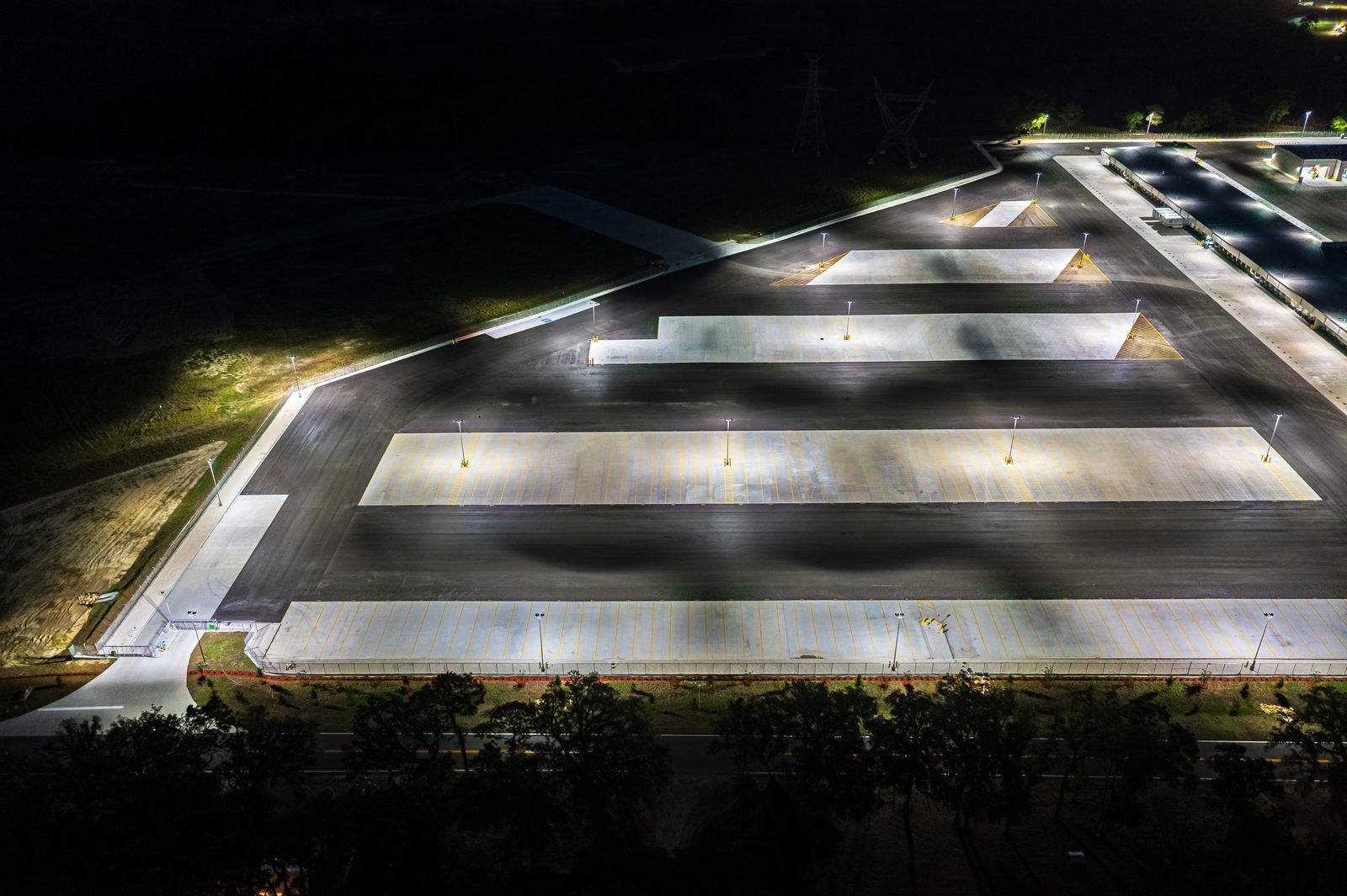 Old Dominion LTL terminal Wildwood FL night drone photo — completed warehouse exterior lighting