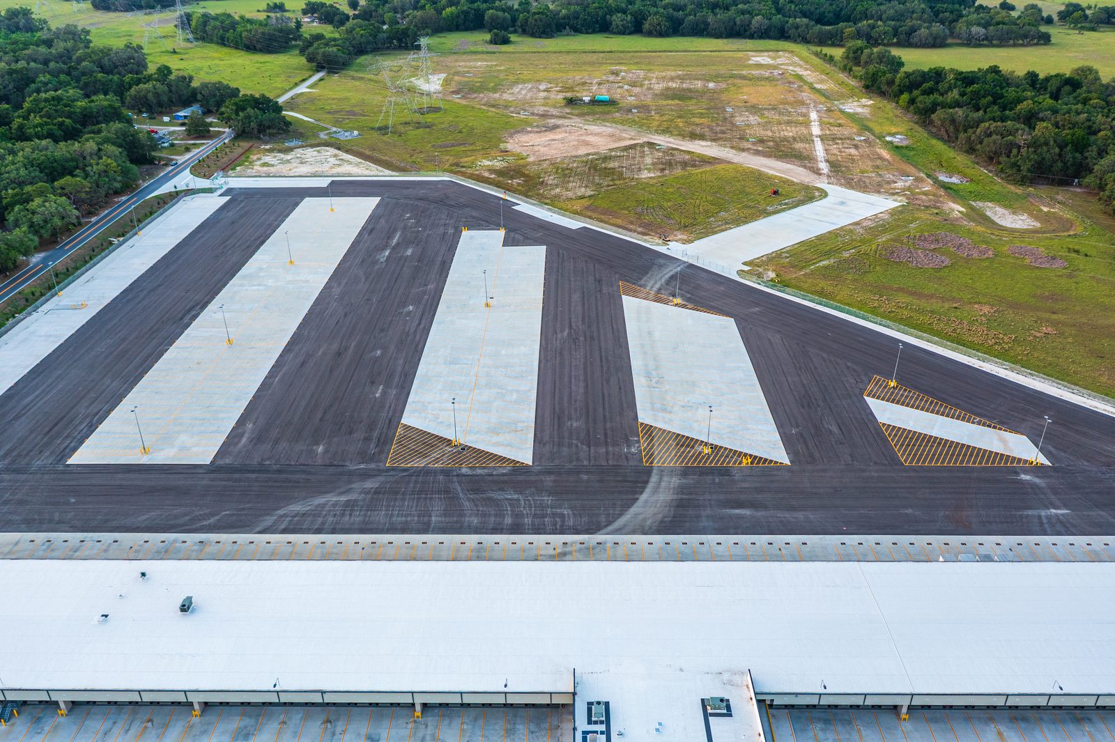Old Dominion Freight Line Wildwood FL LTL terminal twilight aerial photo — dock doors illuminated at dusk
