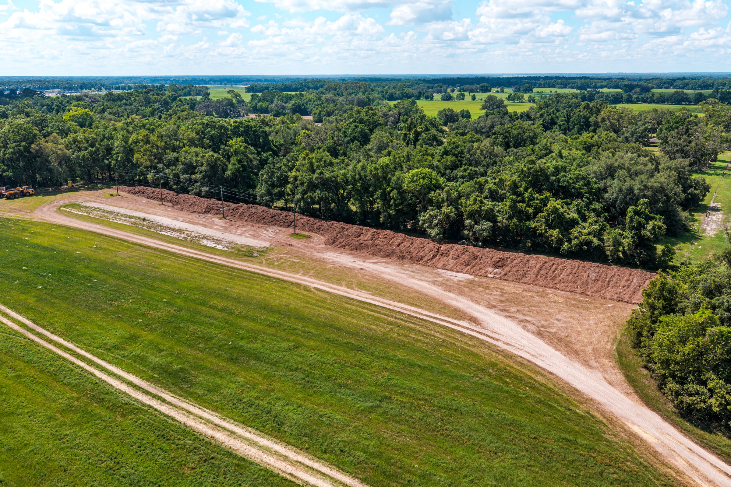 Adjacent property boundary & existing drainage swale — pre-disturbance