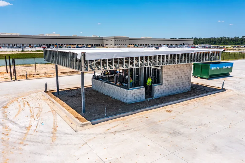 Aerial drone photo of BEK construction site in Alachua, FL — building exterior and site overview, visit 66, June 2026