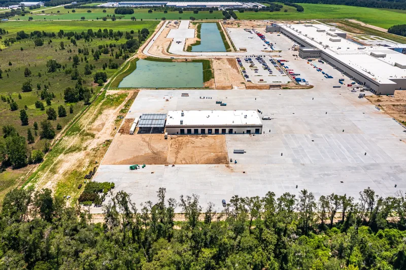 Aerial drone photo of BEK construction site in Alachua, FL — rooftop and parking area progress, visit 66, June 2026