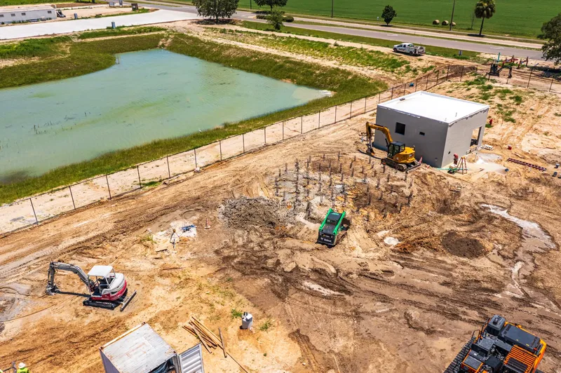 Aerial drone photo of BEK construction site in Alachua, FL — full site overview with completed structures, visit 66, June 2026
