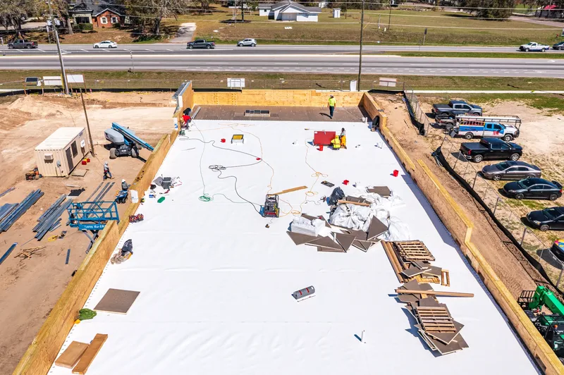 Aerial drone photo of a retail construction site in Alachua, FL — storefront and site work progress
