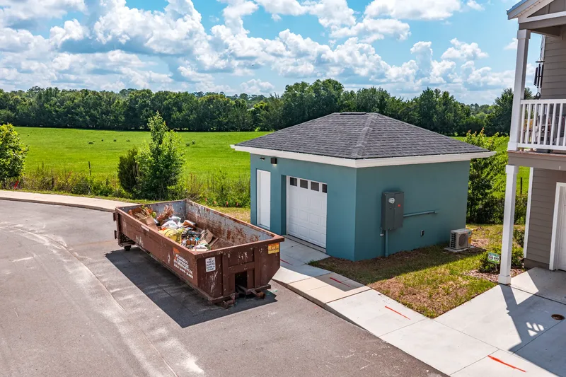 Aerial drone photo of Oak Isle Cottage Homes residential construction site — foundation and framing progress, visit 4, June 2026