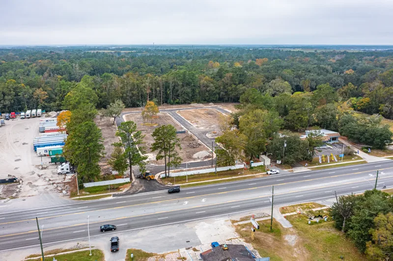 Aerial drone photo of Sunny Pines RV Park in Jacksonville, FL — site overview showing RV pads and amenities