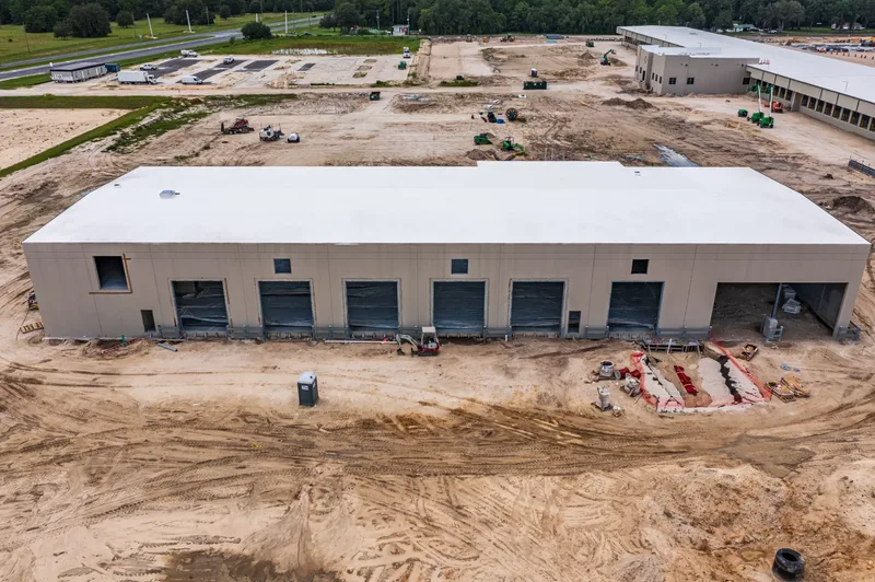 Aerial drone photo of the Old Dominion Wildwood terminal — tilt-wall panel installation and site grading, visit 21, July 2024