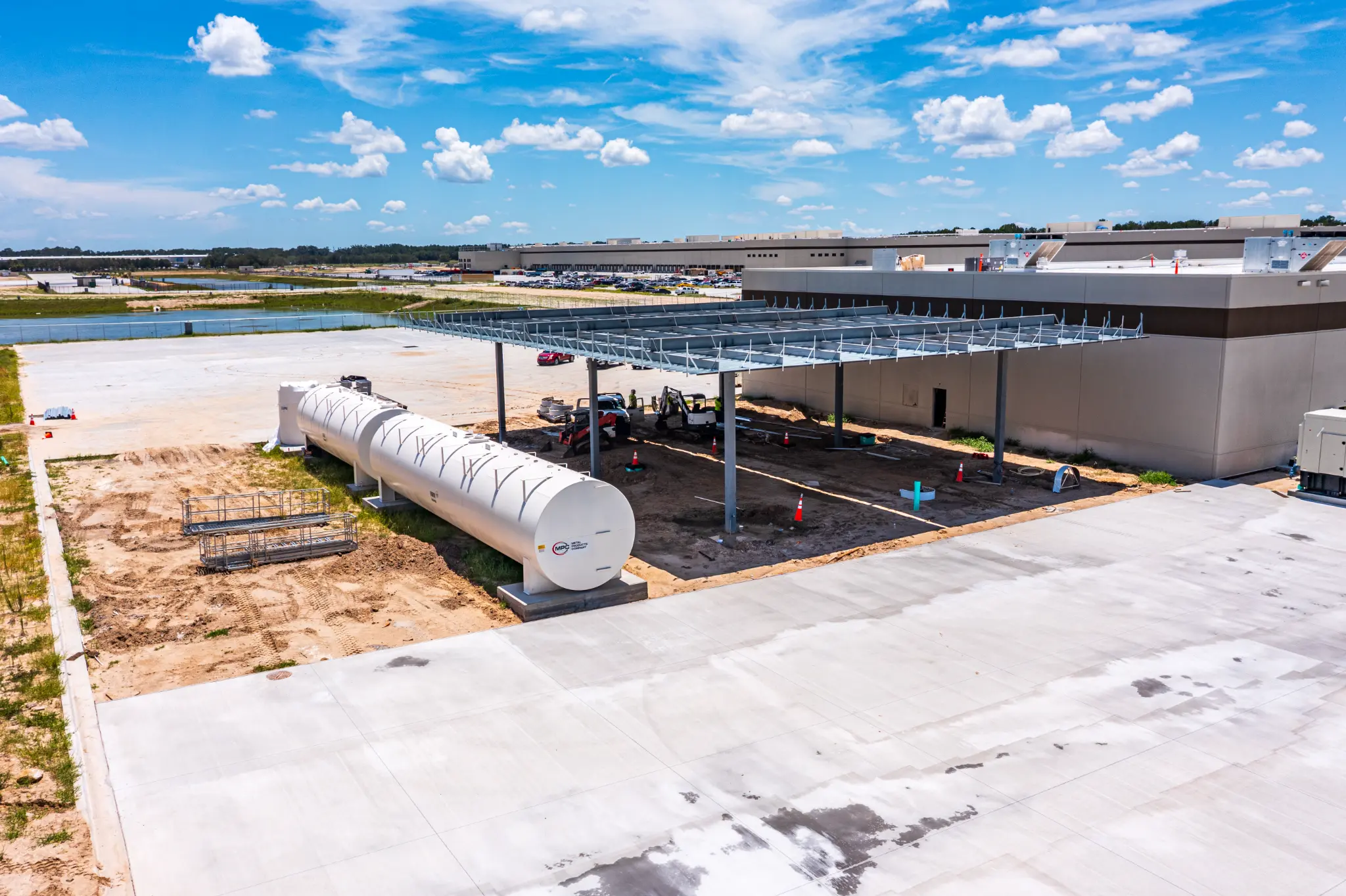 Fuel storage tank and steel canopy frame at a large commercial construction site near Gainesville, FL