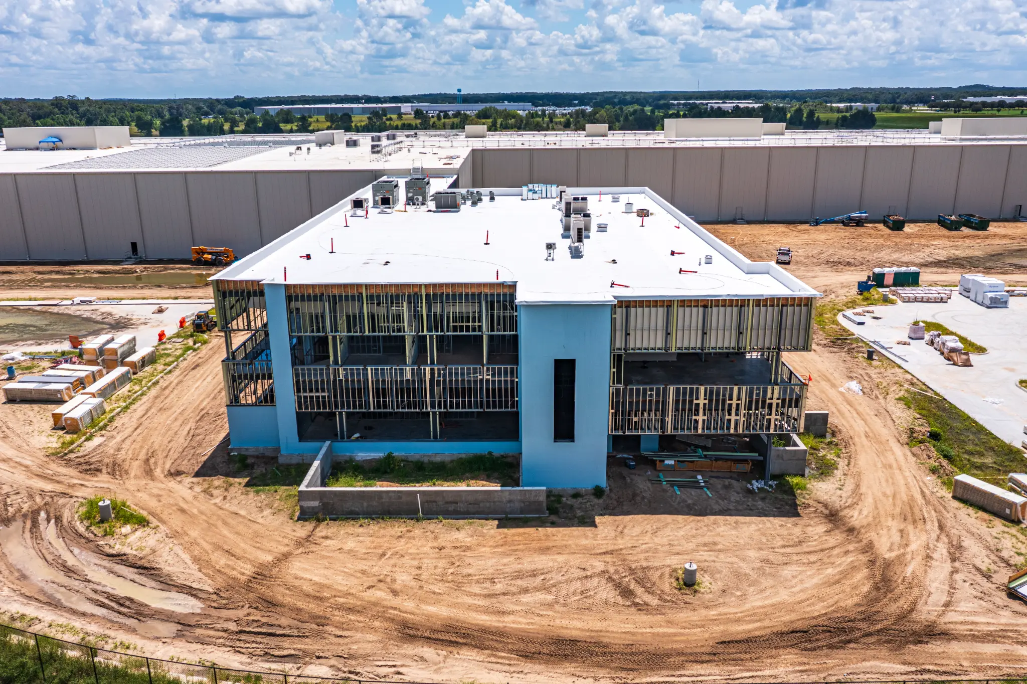 Aerial drone photo of the multi-story office building under construction adjacent to the Ben E. Keith Foods warehouse in Alachua, FL