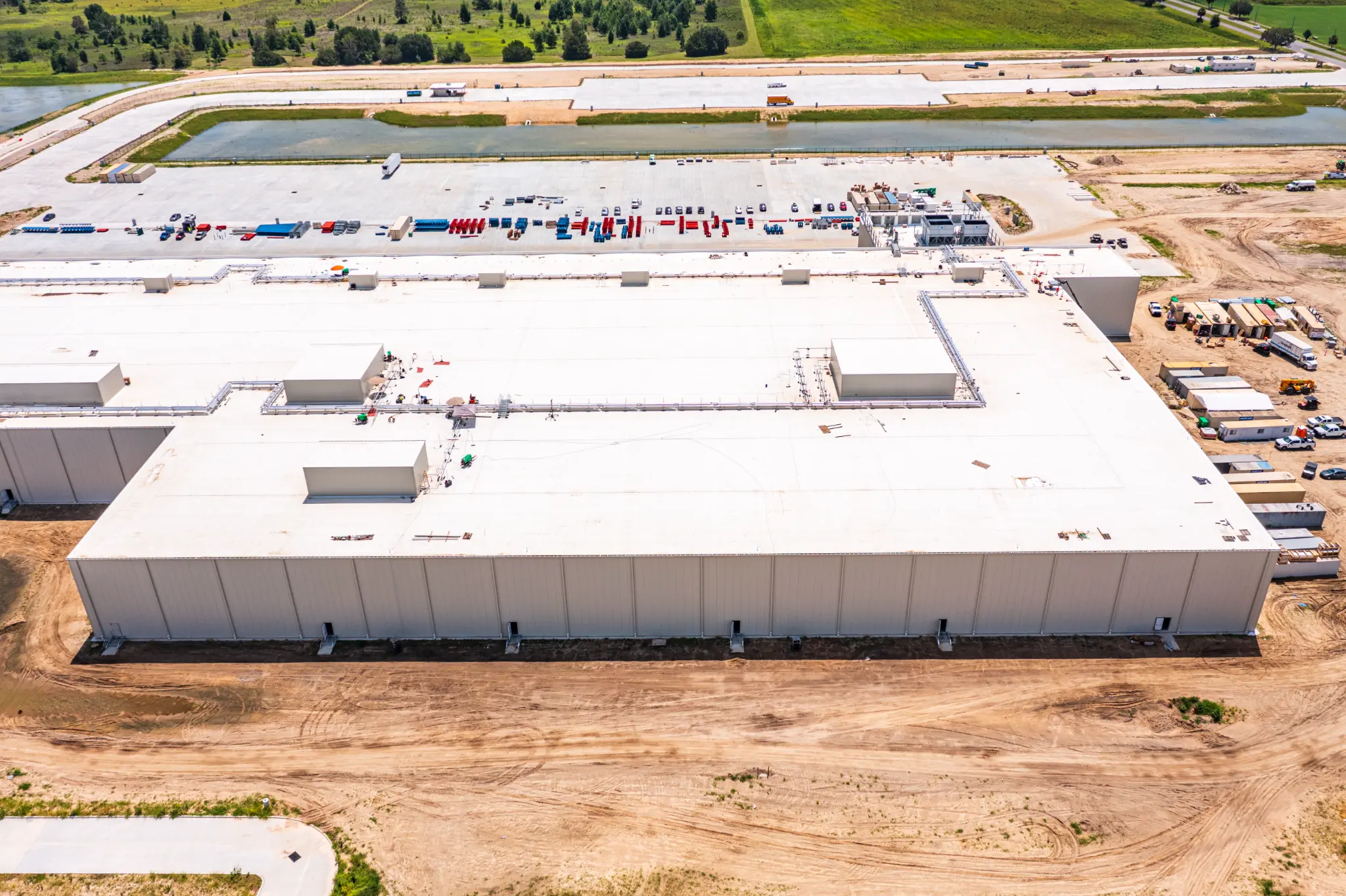 Aerial side view of the completed 707,000 sq ft Ben E. Keith Foods warehouse with loading dock doors and staging yard, Alachua FL — Visit 67